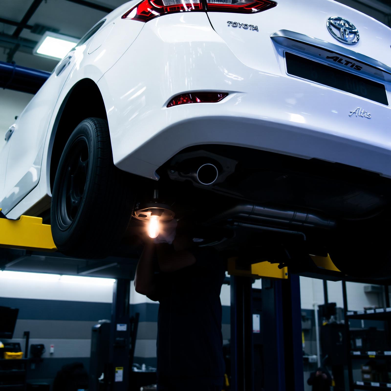 Toyota Altis raised on a workshop lift